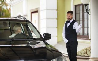 parking-valet-welcoming-woman-with-car